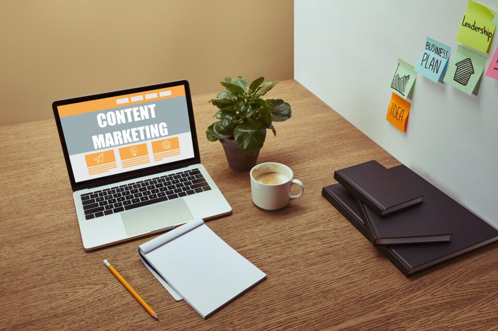 laptop with"content marketing" lettering on screen, notebooks and pencil on wooden tabletop, Data and Analytics for Better Content Marketing